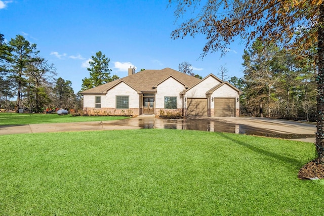 view of front of property with a garage and a front lawn