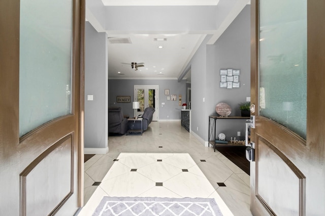 tiled entrance foyer featuring ornamental molding