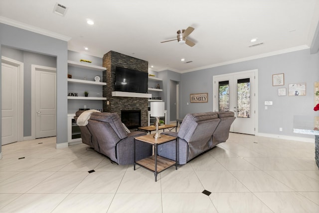 tiled living room featuring ceiling fan, ornamental molding, a stone fireplace, and built in features