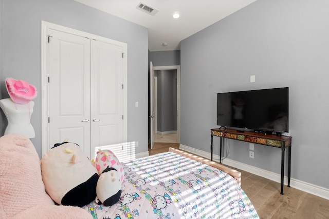 bedroom with a closet and light hardwood / wood-style flooring