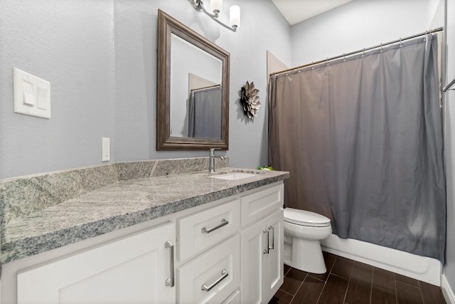 full bathroom featuring shower / bath combination with curtain, vanity, and toilet