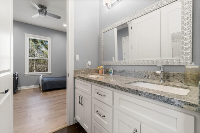 bathroom with ceiling fan, wood-type flooring, and vanity