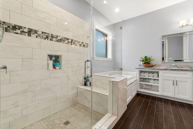 bathroom featuring vanity and separate shower and tub