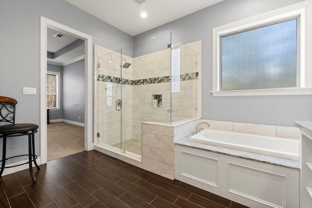 bathroom featuring separate shower and tub