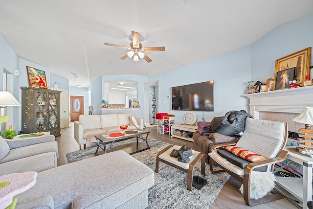 living room featuring ceiling fan and light wood-type flooring