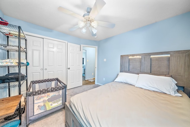 bedroom featuring ceiling fan, light colored carpet, and a closet