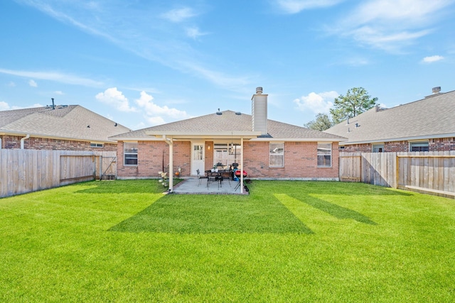 back of house featuring a yard and a patio area