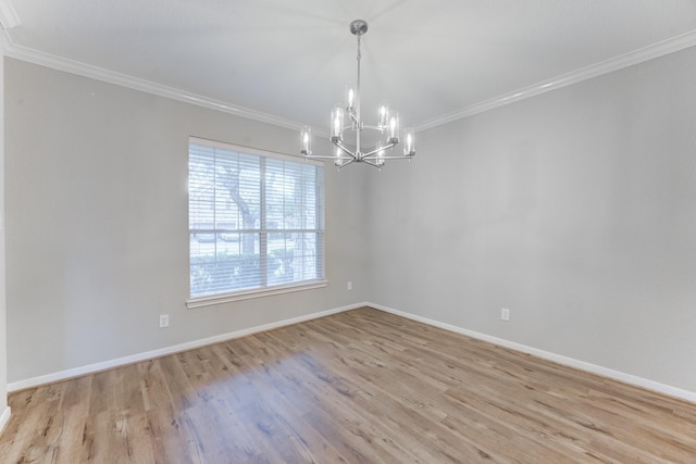 empty room featuring a notable chandelier, crown molding, and light wood-type flooring