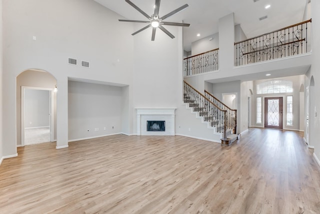 unfurnished living room featuring ceiling fan and light hardwood / wood-style flooring