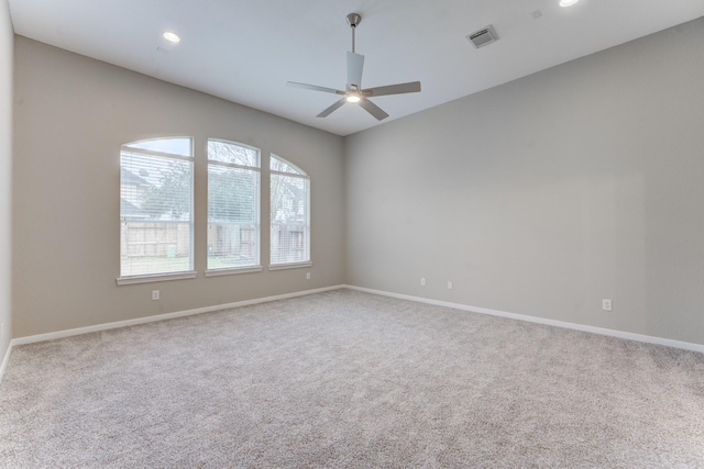 carpeted spare room featuring ceiling fan