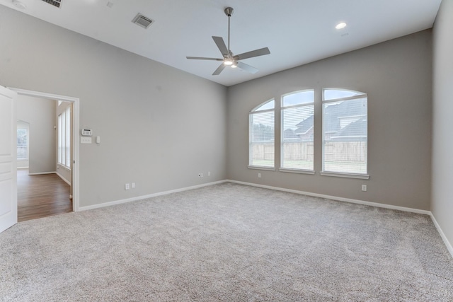 spare room featuring ceiling fan and carpet