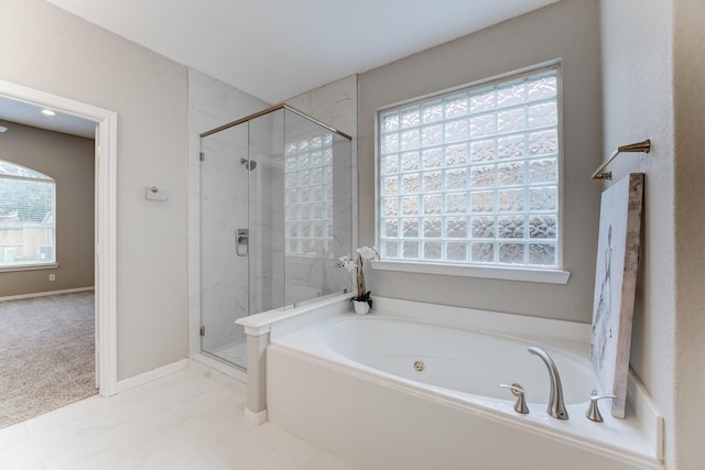 bathroom featuring shower with separate bathtub