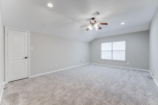 carpeted spare room with lofted ceiling and ceiling fan