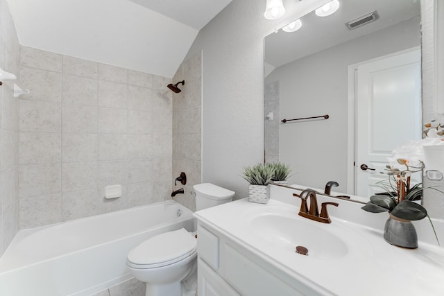 full bathroom with vanity, toilet, and tiled shower / bath combo