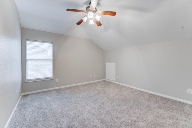 bonus room with ceiling fan, vaulted ceiling, and light carpet