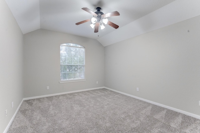 carpeted empty room featuring lofted ceiling and ceiling fan