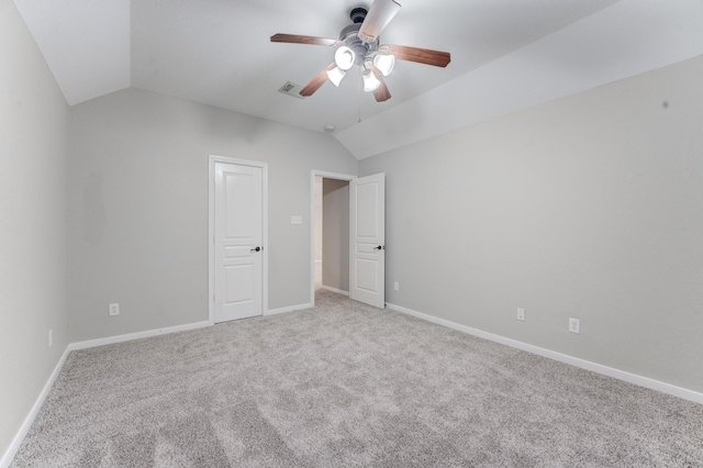 unfurnished bedroom featuring ceiling fan, lofted ceiling, and light carpet