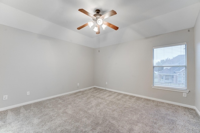 empty room with ceiling fan, light colored carpet, and lofted ceiling