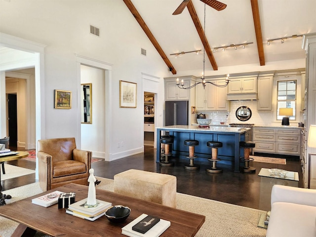 living room featuring ceiling fan, dark wood-type flooring, high vaulted ceiling, and beamed ceiling