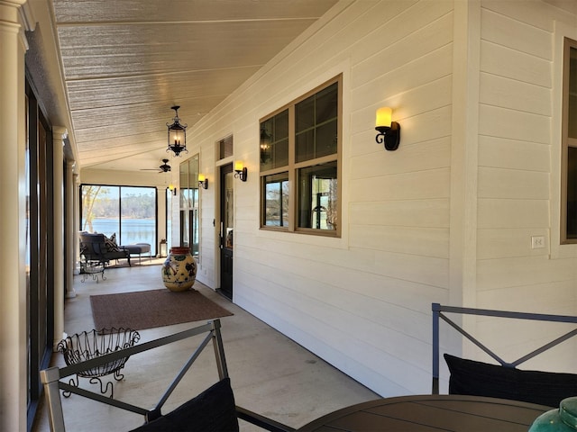 sunroom / solarium featuring ceiling fan, lofted ceiling, and wood ceiling