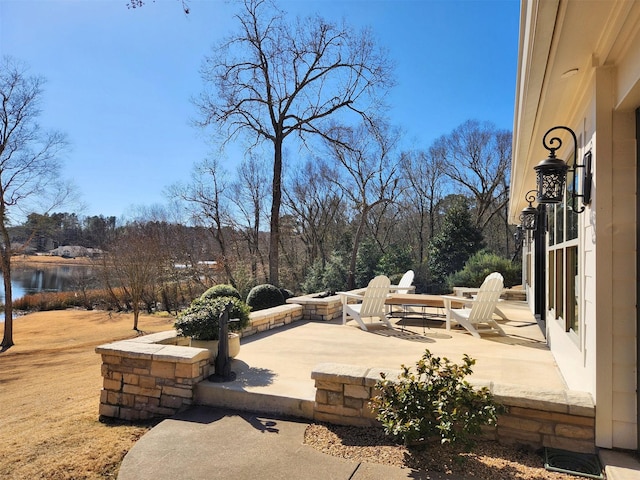 view of patio featuring a fire pit and a water view