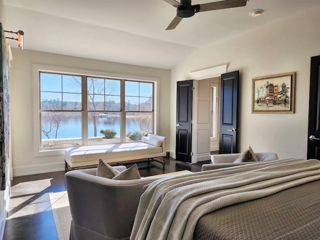 bedroom with vaulted ceiling, a water view, ceiling fan, and dark hardwood / wood-style flooring