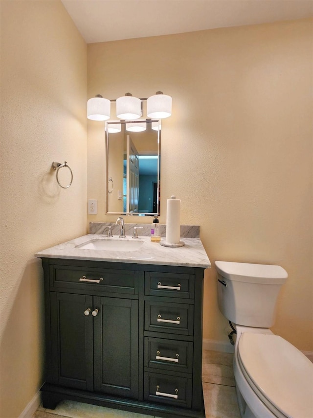 bathroom featuring vanity, tile patterned floors, and toilet