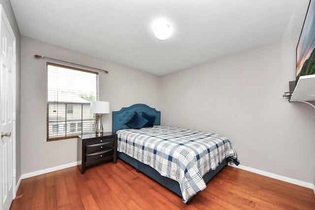 bedroom featuring dark hardwood / wood-style flooring