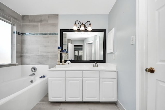 bathroom featuring vanity, a healthy amount of sunlight, and a bathing tub