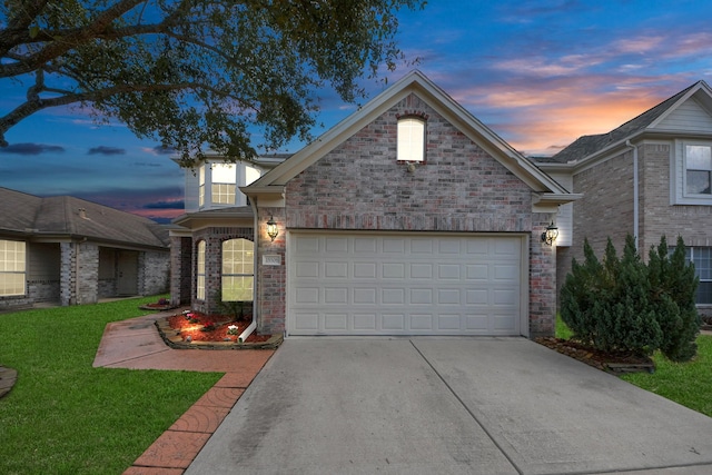 view of front facade featuring a garage and a lawn