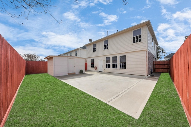 back of house with a storage unit, a yard, and a patio area