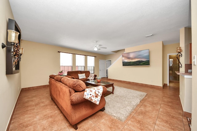 living room featuring ceiling fan and light tile patterned flooring