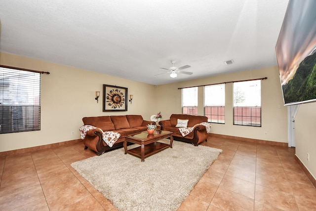 living room featuring light tile patterned flooring, a wealth of natural light, and ceiling fan