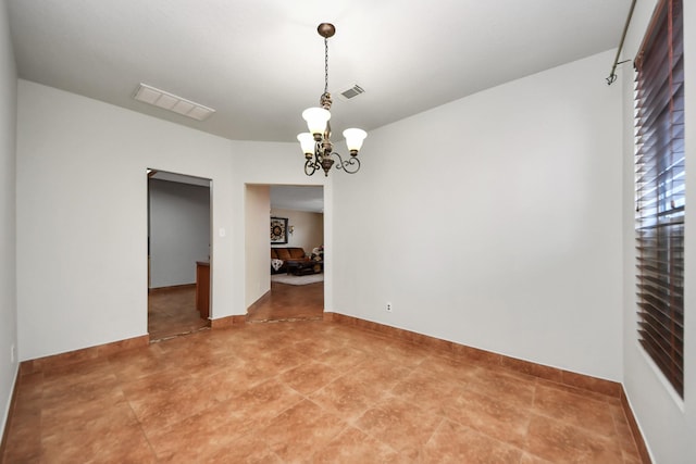 empty room with a notable chandelier