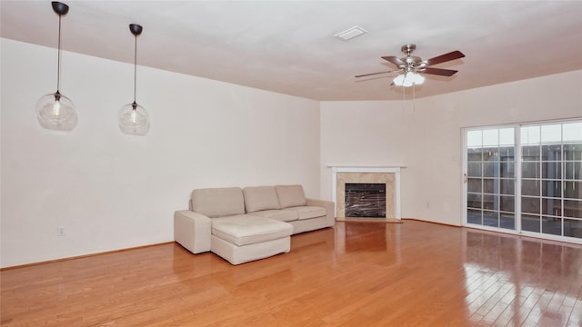 unfurnished living room featuring wood-type flooring and ceiling fan