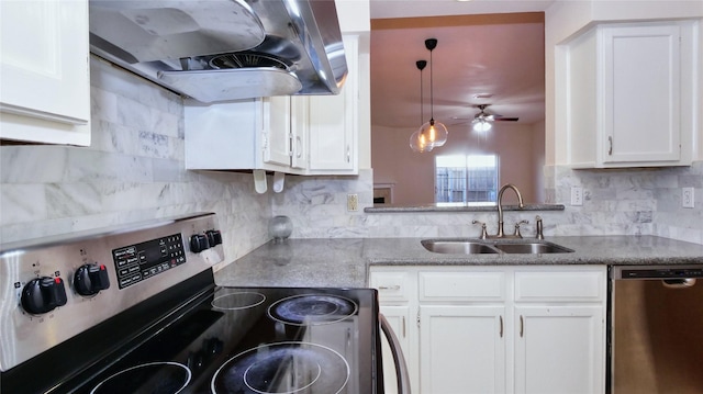 kitchen featuring pendant lighting, sink, range hood, stainless steel appliances, and white cabinets