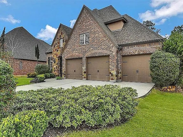 view of home's exterior with a garage and a lawn