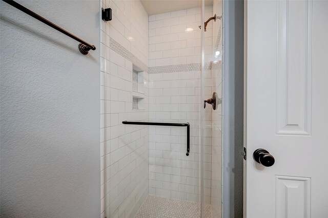 bathroom with a shower with shower door