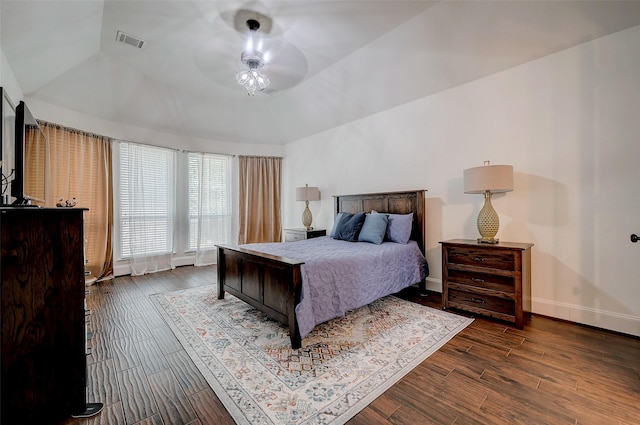 bedroom with lofted ceiling and wood-type flooring