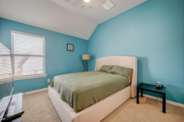 bedroom with vaulted ceiling and carpet floors