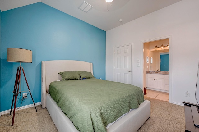 carpeted bedroom featuring sink and lofted ceiling