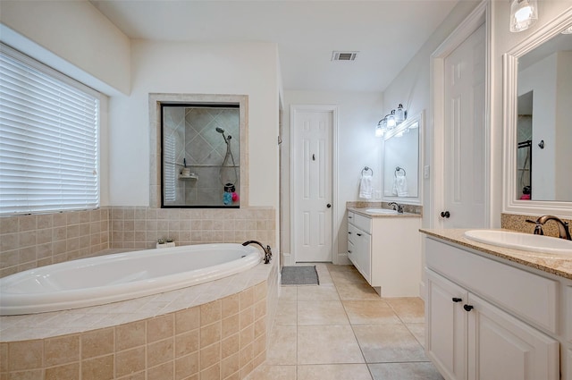 bathroom featuring tile patterned floors, independent shower and bath, and vanity