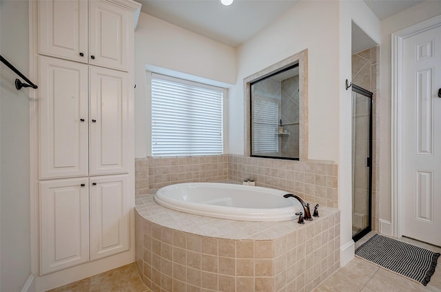 bathroom featuring plus walk in shower and tile patterned floors