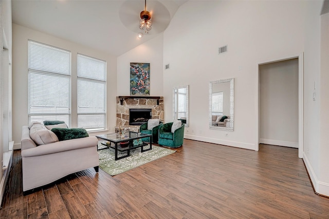 living room featuring a fireplace, high vaulted ceiling, hardwood / wood-style floors, and ceiling fan