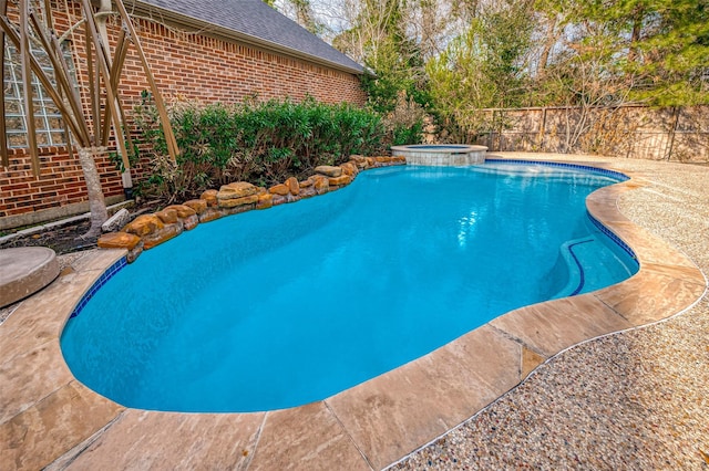 view of swimming pool featuring an in ground hot tub