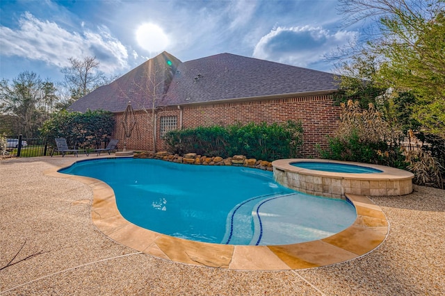 view of swimming pool featuring a patio and an in ground hot tub