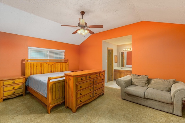 carpeted bedroom with ceiling fan, connected bathroom, vaulted ceiling, and a textured ceiling