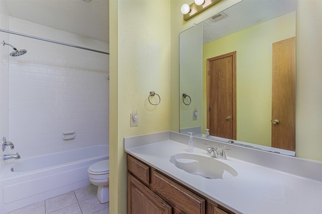 full bathroom with toilet, tiled shower / bath, a textured ceiling, vanity, and tile patterned flooring