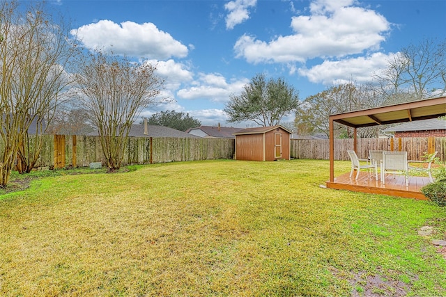 view of yard with a deck and a storage unit