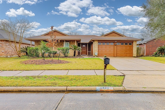 ranch-style home featuring a garage and a front yard